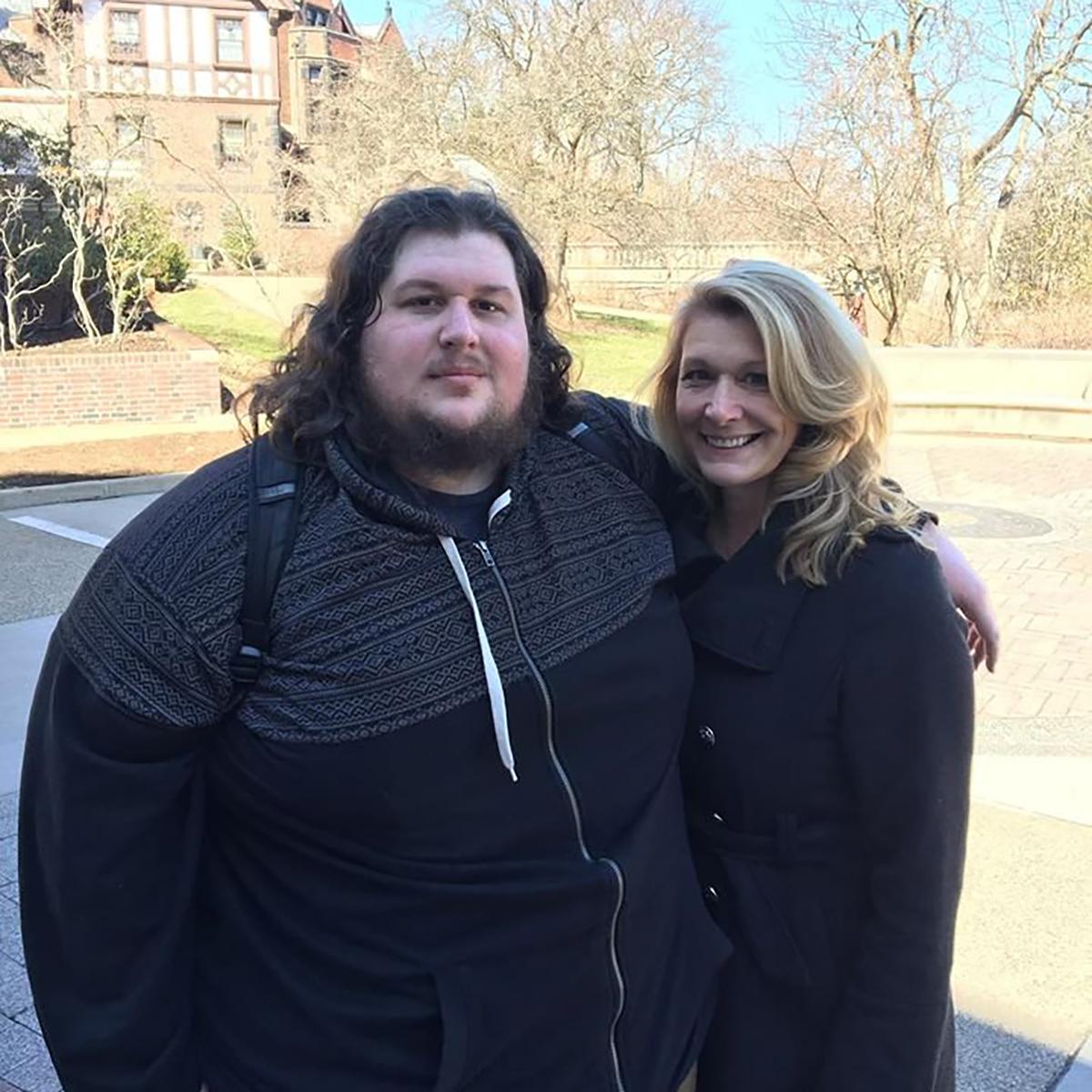 Photo of Christopher posing with a woman on Shadyside Campus