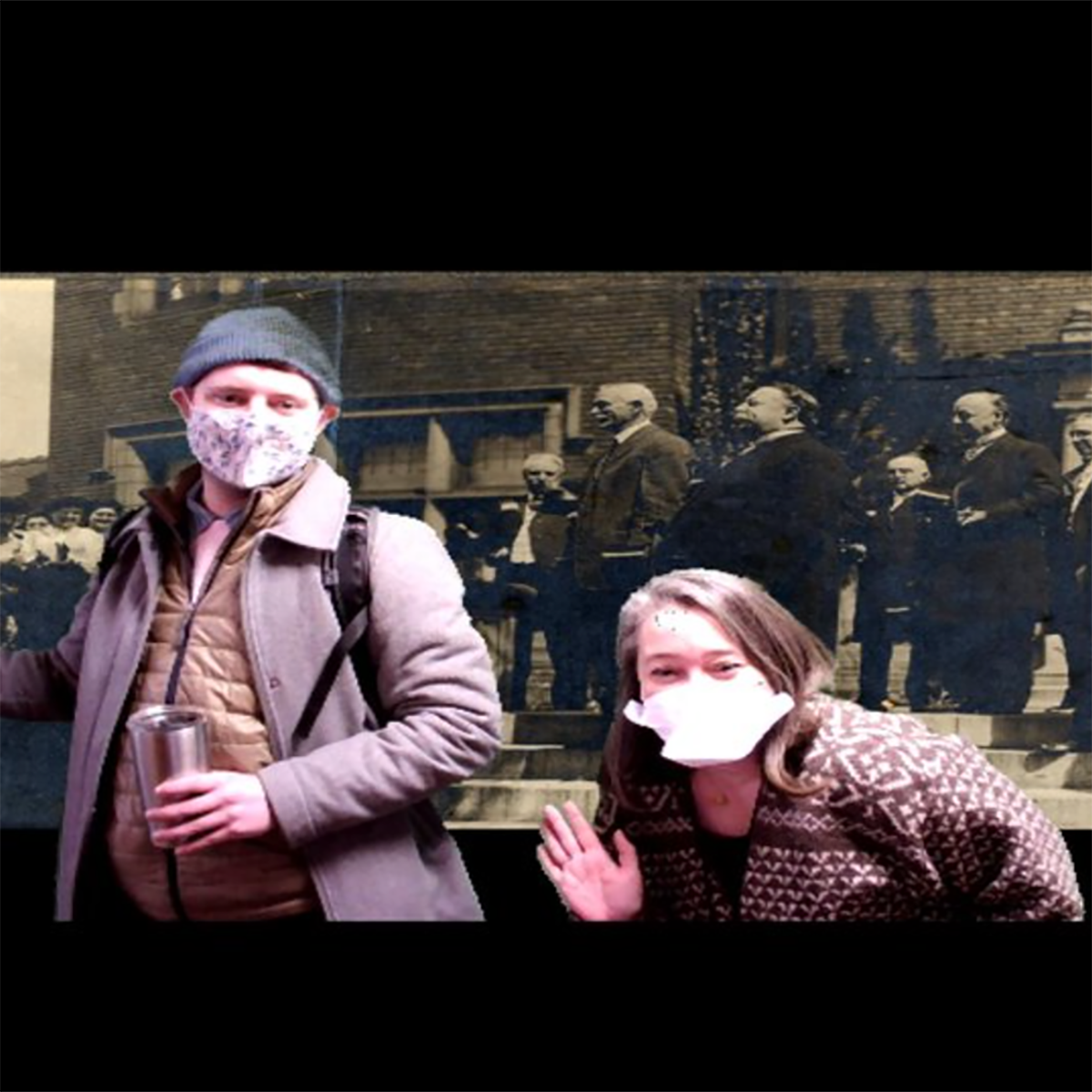 Photo of two students in masks posing in front of a historical photograph
